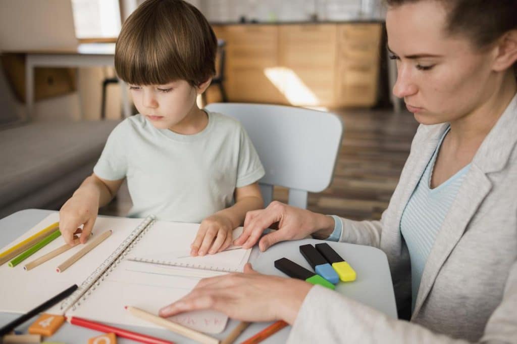 side view female tutor teaching child home